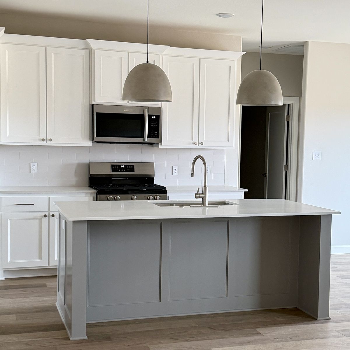 Finished white kitchen with pendant lights